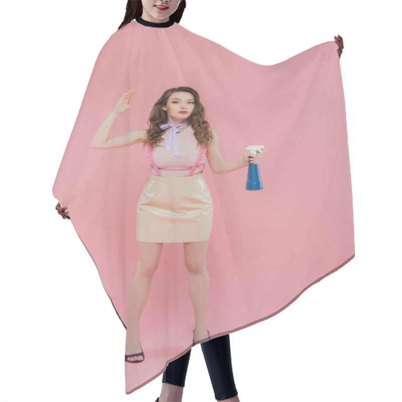 Personality  Concept Photography, Housekeeping, Young Woman With Wavy Hair Pretending To Be A Doll And Doing House Cleaning, Gesturing And Standing On Pink Background, Housewife With Spray Bottle  Hair Cutting Cape