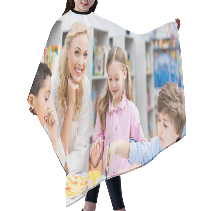 Personality  Panoramic Shot Of Happy Woman Looking At Camera Near Cute Kids  Hair Cutting Cape