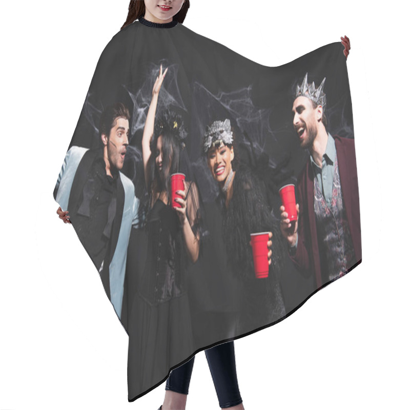 Personality  Excited Multiethnic Friends In Halloween Costumes Dancing With Plastic Cups On Black   Hair Cutting Cape