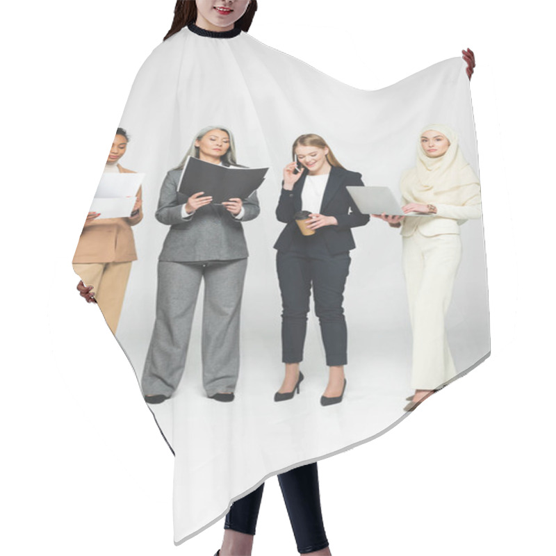 Personality  Multicultural Businesswomen With Folders Near Woman Talking On Smartphone On White  Hair Cutting Cape