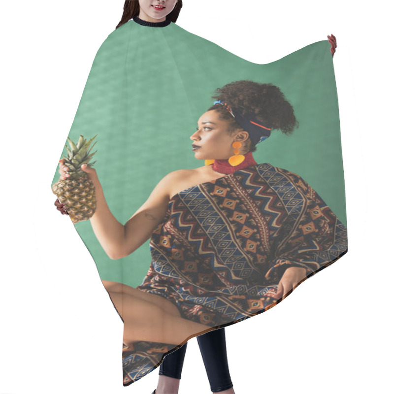 Personality  African American Woman Wrapped In Ornament Blanket Holding Pineapple On Green Textured Background Hair Cutting Cape