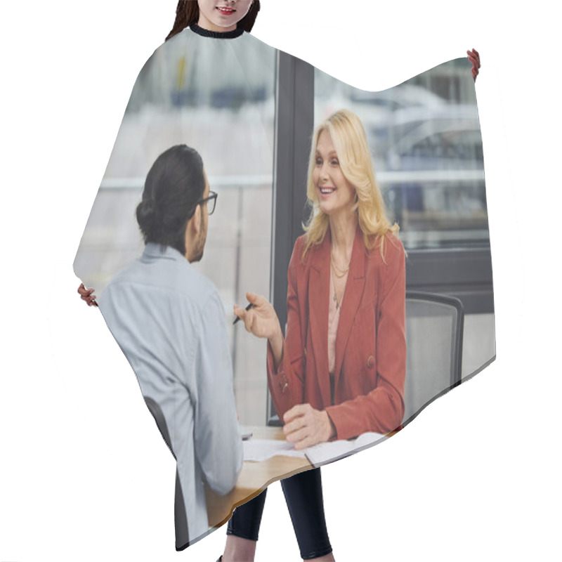 Personality  A Woman And Man Discussing Business At An Office Table. Hair Cutting Cape