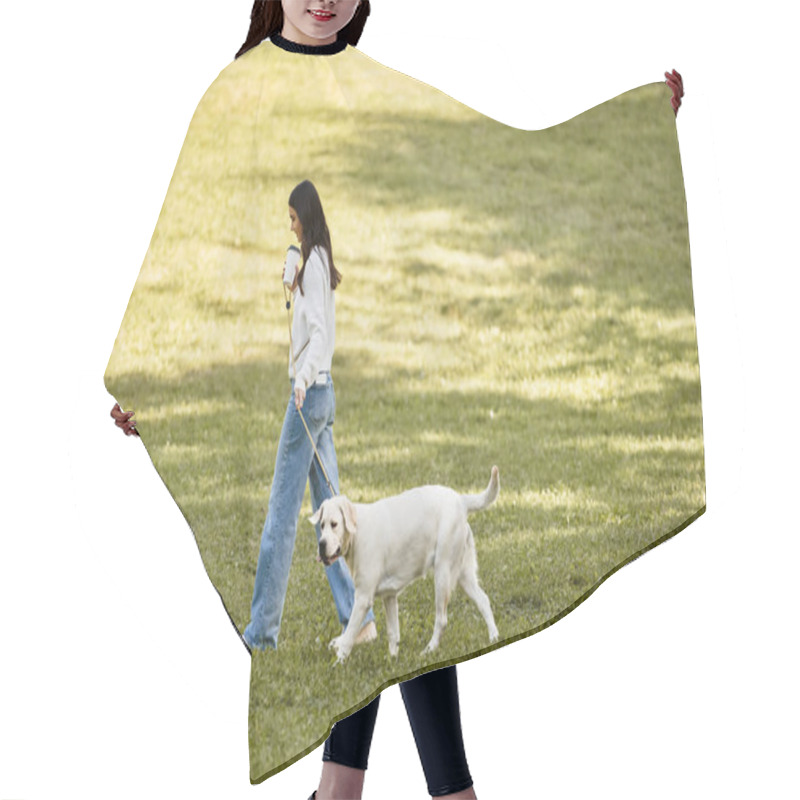 Personality  A Young Woman In Warm Autumn Attire Happily Walks Her Dog Through A Serene Park Setting. Hair Cutting Cape