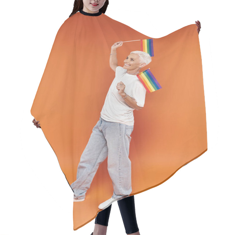 Personality  A Mature Woman With Short Hair Joyfully Waves Rainbow Flags In Celebration. Hair Cutting Cape