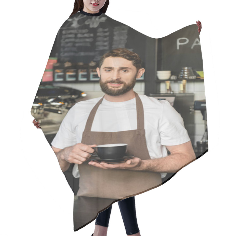 Personality  Smiling Bearded Barista In Apron Holding Cup Of Coffee And Looking At Camera In Coffee Shop Hair Cutting Cape