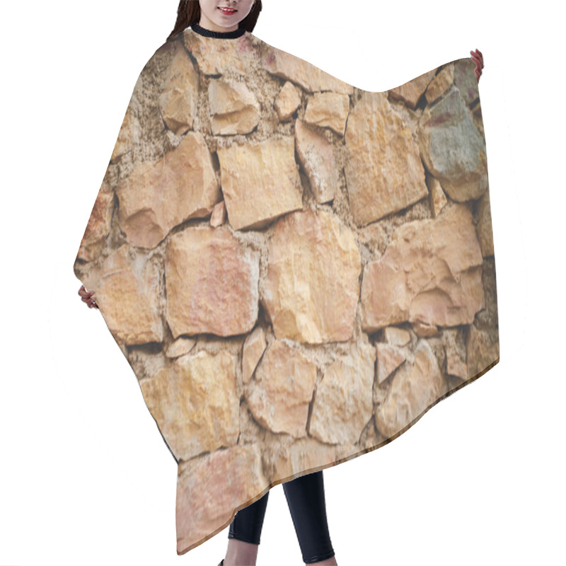 Personality  A Close-up View Of A Rustic Stone Wall Made Of Irregularly Shaped Stones In Warm Earthy Tones. The Texture Of The Stones Is Rough And Weathered, Showcasing Natural Variations In Color And Size. Hair Cutting Cape