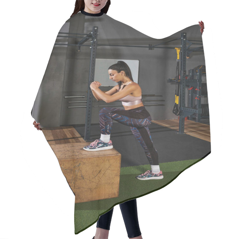 Personality  A Woman Performs A Strength Building Exercise On A Sturdy Box In A Gym Environment. Hair Cutting Cape