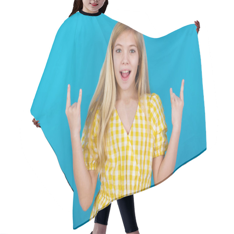 Personality  Beautiful Caucasian Girl Wearing Dress  Makes Rock N Roll Sign Looks Self Confident And Cheerful Enjoys Cool Music At Party. Body Language Concept. Hair Cutting Cape