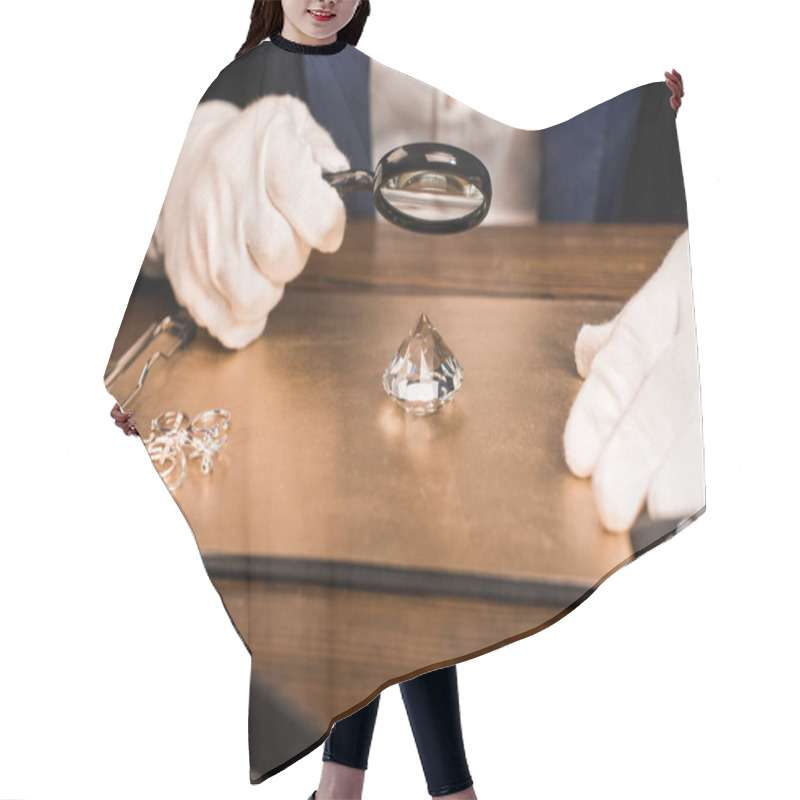 Personality  Cropped View Of Jewelry Appraiser Examining Gemstone With Magnifying Glass Near Jewelry On Board On Table Isolated On Black  Hair Cutting Cape