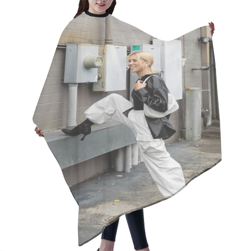 Personality  Full Length Of Cheerful Woman In Leather Shirt Jacket And Cargo Pants Posing With Handbag On Industrial Street In Miami  Hair Cutting Cape