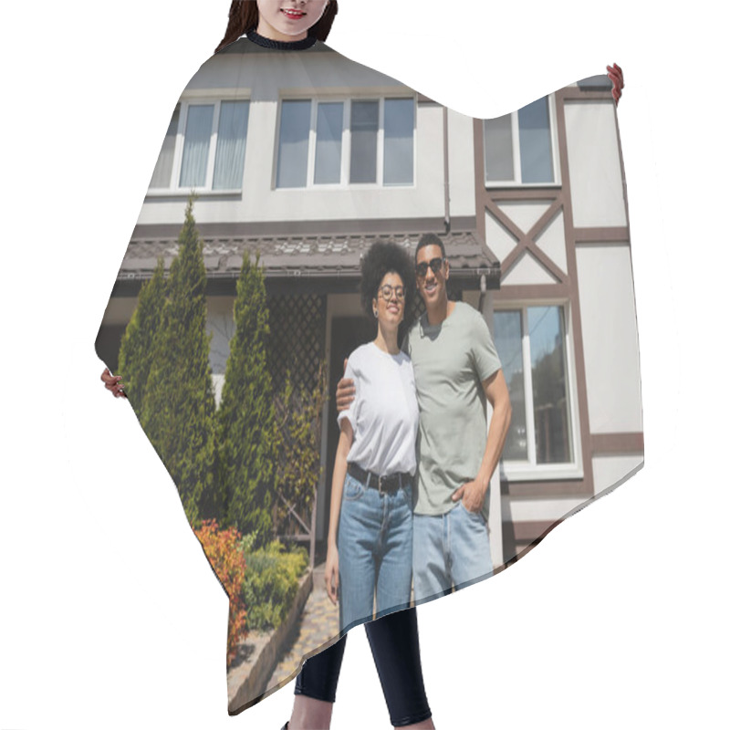 Personality  Positive African American Couple Hugging While Standing Near New House On Background Hair Cutting Cape