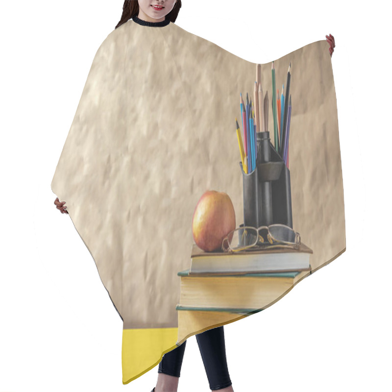 Personality  Back To School Concept. Stack Of Books With School Supplies Hair Cutting Cape