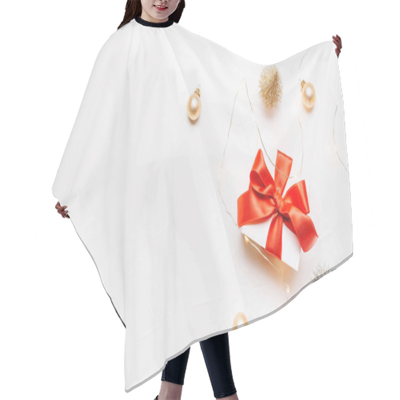 Personality  Christmas Gift. White Gift With Red Bow, Gold Balls And Sparkling Lights Garland In Xmas Decoration On White Background For Greeting Card. Xmas Backdrop With Space For Text Hair Cutting Cape