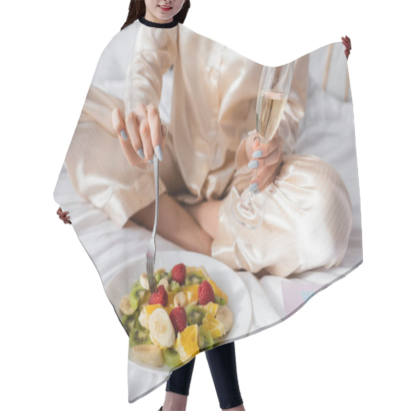 Personality  Cropped View Of Woman With Champagne Holding Fork Near Fruit Salad, Macarons And Birthday Greeting Card On Bed  Hair Cutting Cape