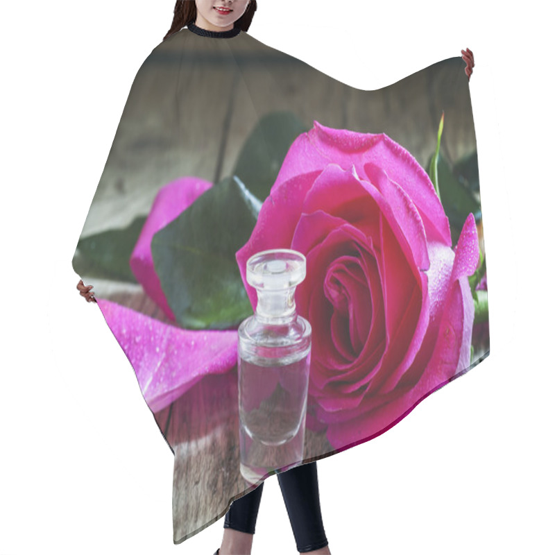 Personality  Rose Essential Oil In A Small Bottle And Pink Rose Hair Cutting Cape