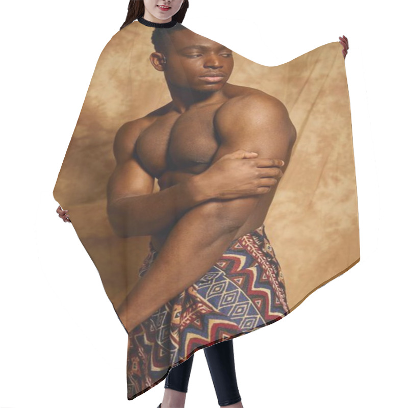 Personality  A Young, Toned African American Man Stands Topless, Showcasing His Strong Physique. Draped In A Patterned Fabric, He Exudes Confidence Against A Warm, Artistic Backdrop That Enhances His Presence. Hair Cutting Cape