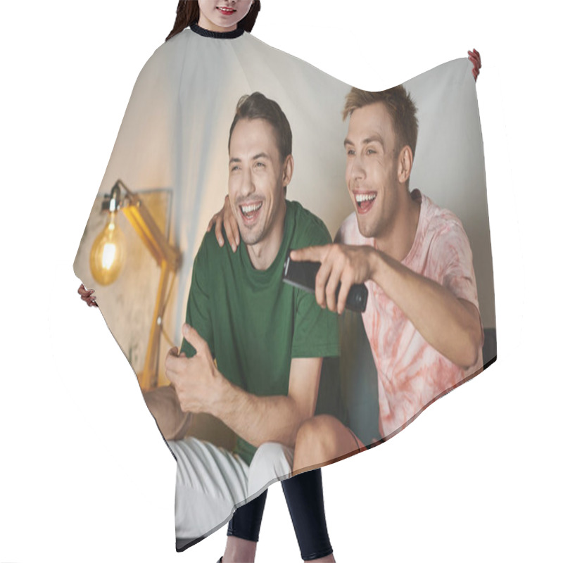 Personality  Two Men Share Smiles And Laughter While Relaxing On The Couch. Hair Cutting Cape