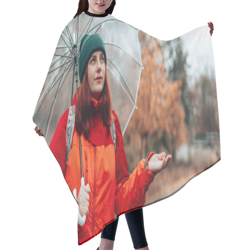 Personality  Positive Caucasian Woman With A Backpack And In Red Jacket Walks Along Wet Rainy Streets Under A Transparent Umbrella. Autumn Forest Walk Hair Cutting Cape