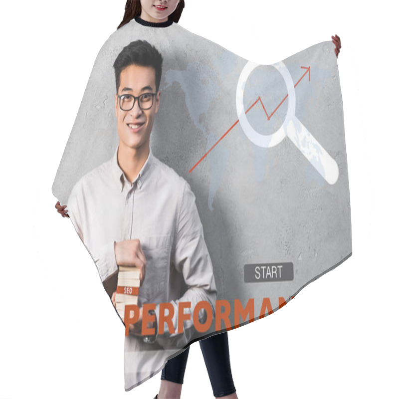 Personality  Smiling Asian Seo Manager Holding Rectangle With Seo Lettering And Standing Near Seo Performance Illustration Hair Cutting Cape