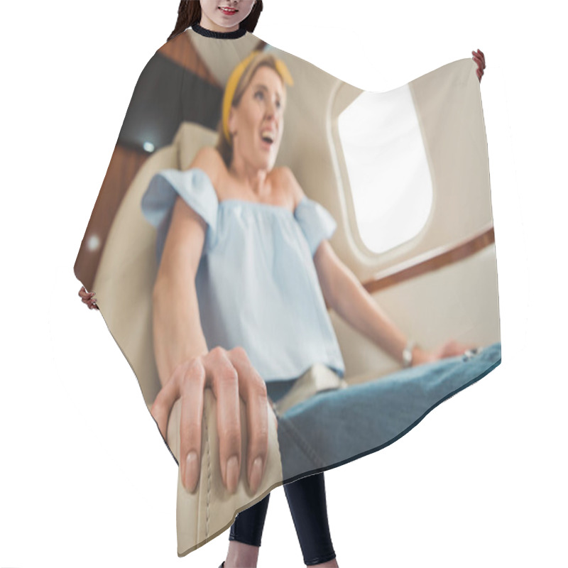 Personality  Selective Focus Of Terrified Woman Scratching Leather Seat In Private Plane  Hair Cutting Cape