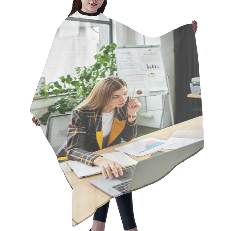 Personality  Attractive Young Woman Dressed In A Checkered Blazer Works Diligently At Her Office Desk. Hair Cutting Cape