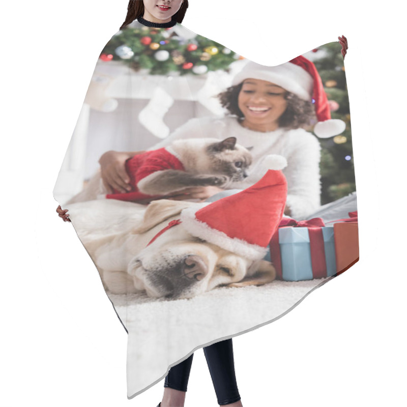 Personality  Labrador Dog In Santa Hat Sleeping Near Cheerful African American Girl And Cat On Blurred Background Hair Cutting Cape