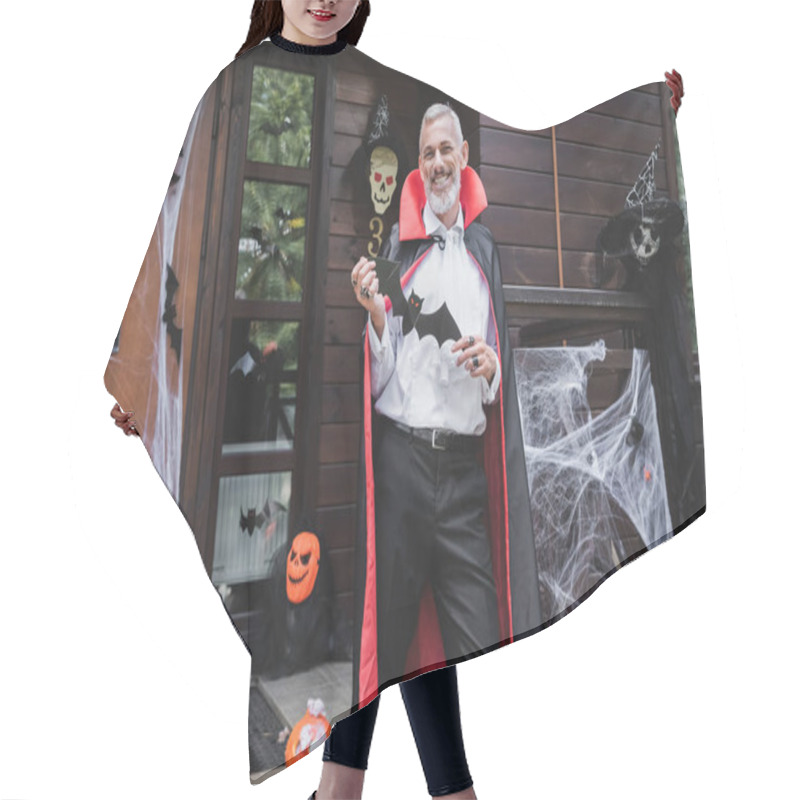 Personality  Happy Mature Man In Vampire Halloween Costume Standing On Decorated Porch With Pape Cut Bat Hair Cutting Cape