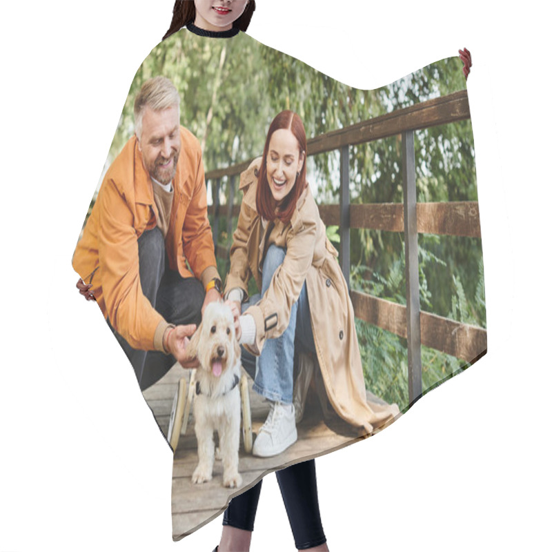 Personality  A Man And Woman In Casual Attire Enjoy Petting A Dog On A Bridge In A Park. Hair Cutting Cape