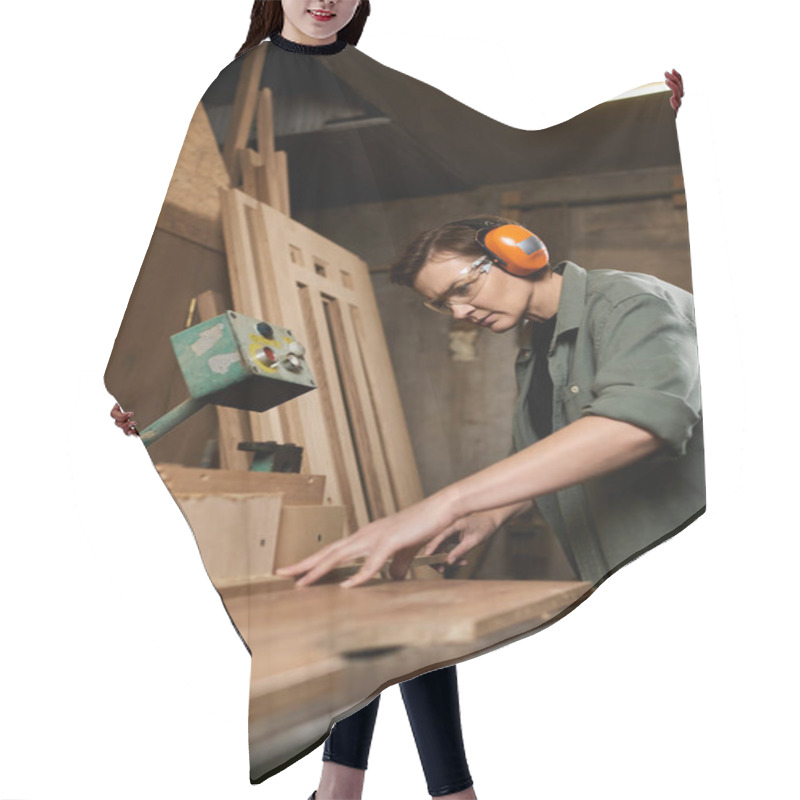 Personality  In A Vibrant Workshop, A Talented Female Carpenter Carefully Crafts Wood While Wearing Protective Gear. Hair Cutting Cape