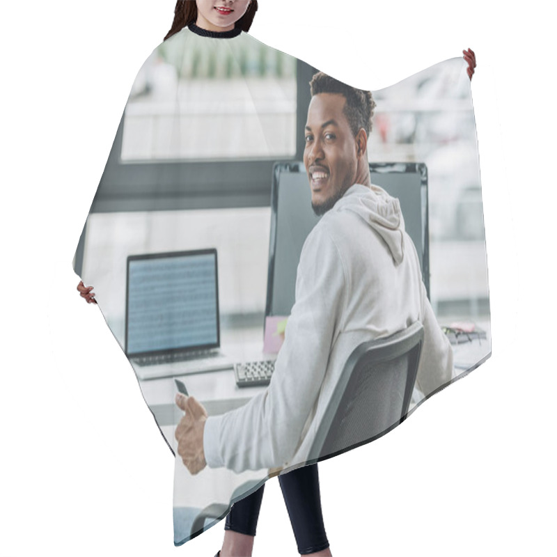 Personality  Happy African American Programmer Smiling At Camera While Sitting At Workplace In Office Hair Cutting Cape