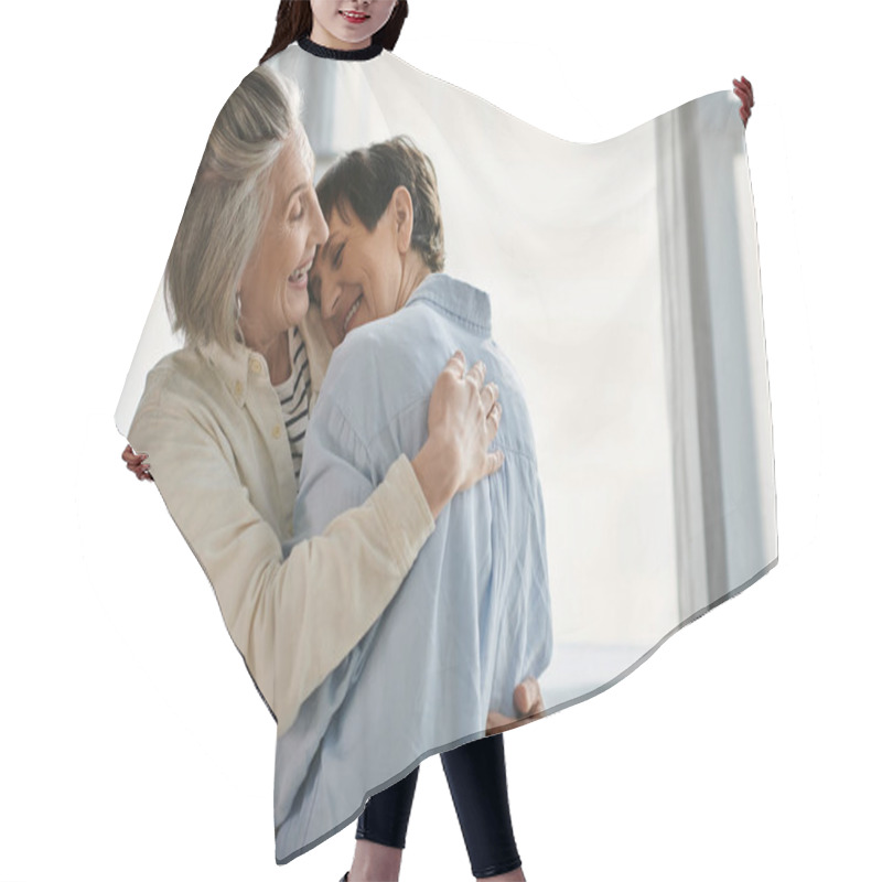 Personality  Two Elderly Women Tenderly Embrace In Sunlight By A Window. Hair Cutting Cape