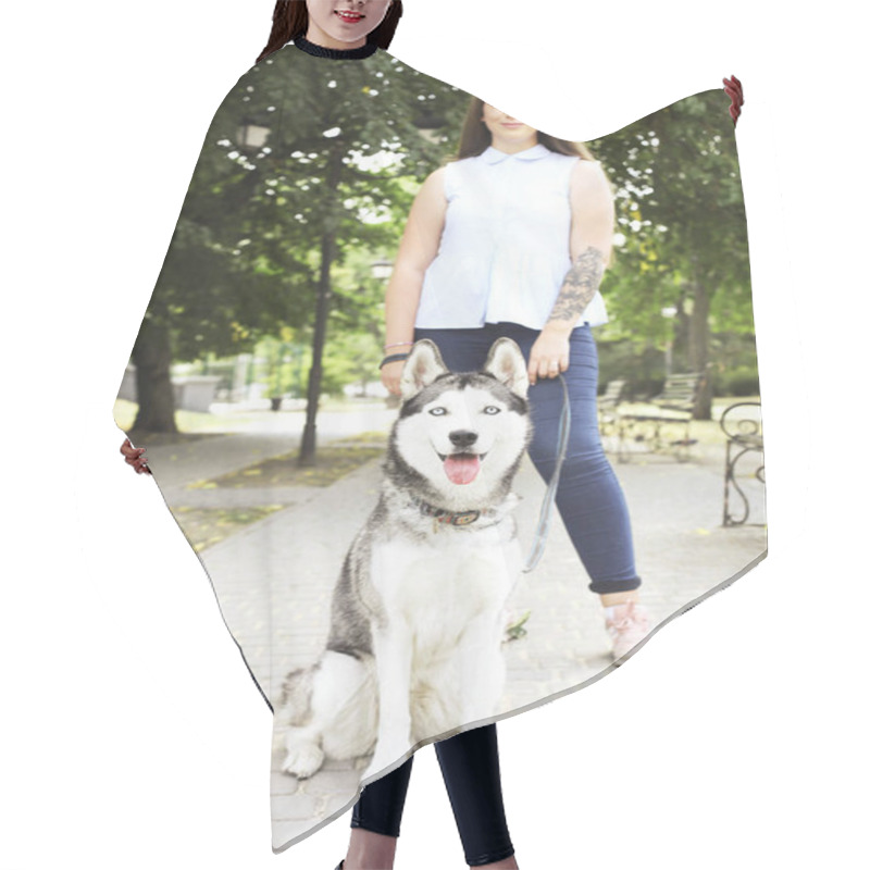 Personality  Young Beautiful Curvy Woman Walking Her Cute Furry Siberian Husky Dog On City Streets. Female In Blue Jeans And White Cotton Blouse With Funny Pet Sticking Tongue Out. Background, Copy Space, Close Up Hair Cutting Cape