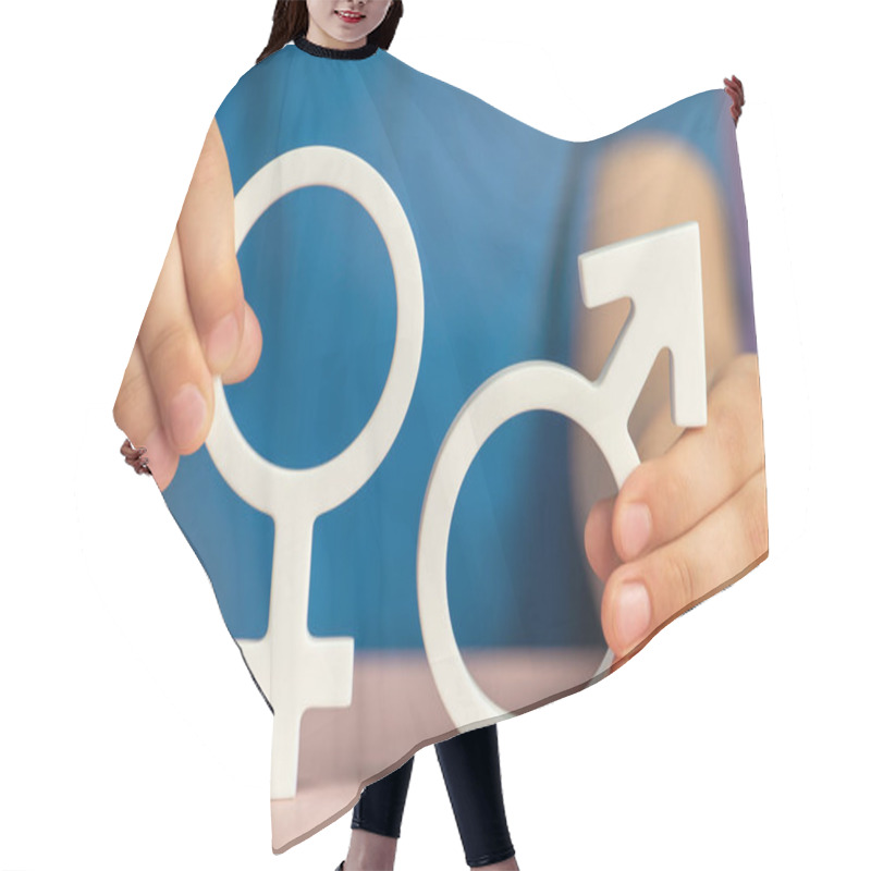 Personality  The Concept Of Gender Equality. Symbol Of Female And Male Gender In Hand As A Symbol Of Equality Of Rights. On A Purple Background In A Blue T-shirt With Copy Space. High Quality Photo Hair Cutting Cape