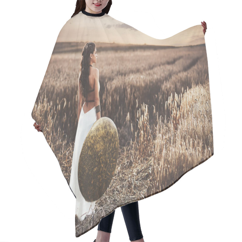 Personality  Back View Of Girl Holding Shield Among Grass In Field. Hair Cutting Cape