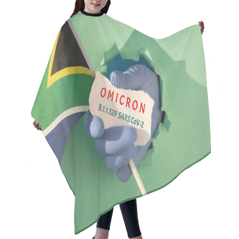 Personality  Omicron, New Corona Virus Variant Of Concern. Hand In Glove From Torn Paper Hole Holds South African Flag And Scrap Of Paper With Name Of The New Coronavirus Variant. Hair Cutting Cape