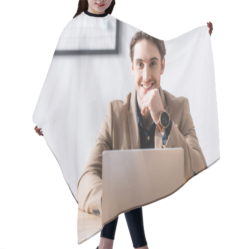 Personality  Smiling Office Worker Looking At Camera While Sitting Near Laptop At Desk In Office On Blurred Background Hair Cutting Cape