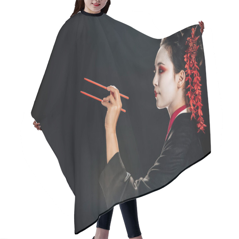 Personality  Side View Of Beautiful Geisha In Black Kimono With Red Flowers In Hair Holding Chopsticks Isolated On Black Hair Cutting Cape