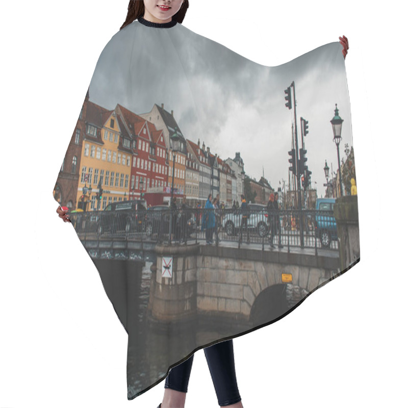 Personality  COPENHAGEN, DENMARK - APRIL 30, 2020: People Walking On Bridge Near Canal With Nyhavn Urban Street And Cloudy Sky At Background   Hair Cutting Cape