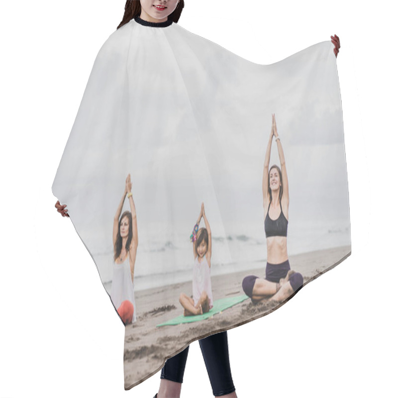 Personality  Two Women And Little Child Practicing Yoga On Seashore On Cloudy Day, Lotus Pose (padmasana) With Namaste Mudra Hair Cutting Cape