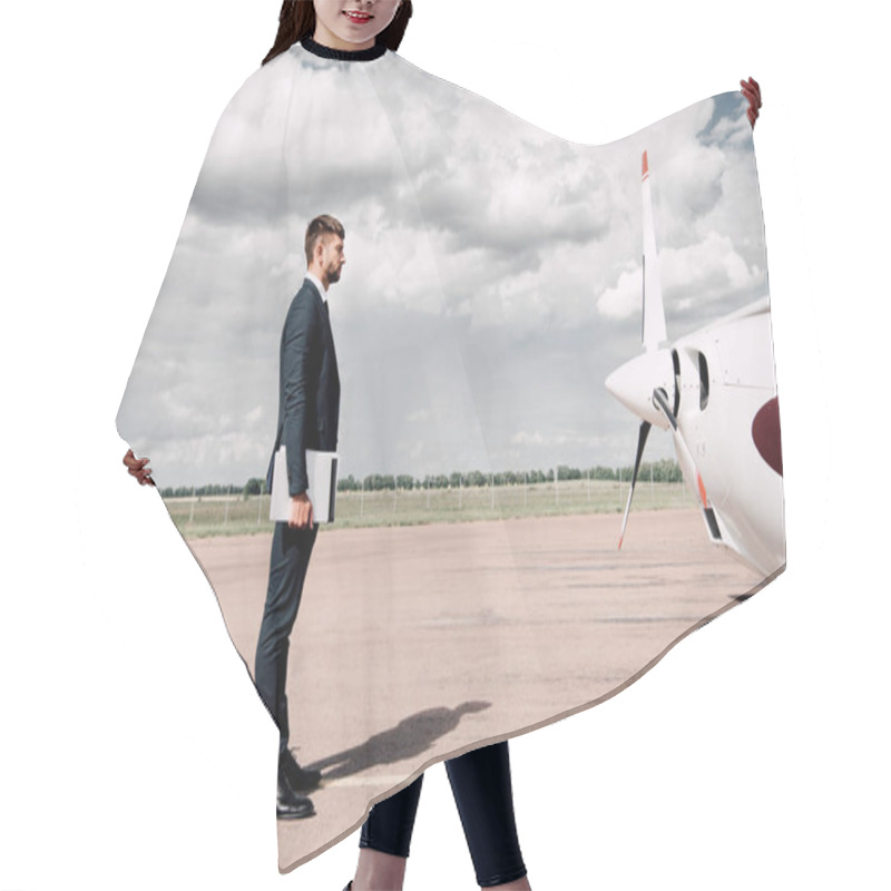 Personality  Side View Of Businessman In Formal Wear Holding Laptop And Folder Near Plane In Sunny Day Hair Cutting Cape