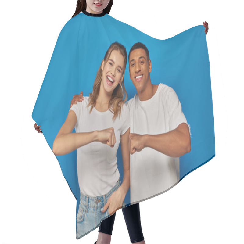 Personality  Happy Interracial Couple Fist Bumping On Blue Backdrop, African American Man And Excited Woman Hair Cutting Cape