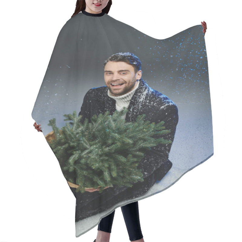 Personality  A Jovial Young Man Embraces A Christmas Tree Surrounded By Falling Snowflakes. Hair Cutting Cape