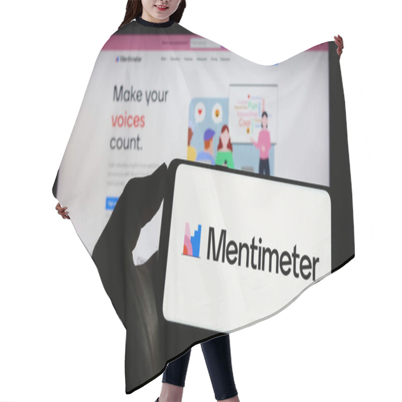 Personality  Stuttgart, Germany - 07-09-2023: Person Holding Mobile Phone With Logo Of Presentation Software Company Mentimeter On Screen In Front Of Business Web Page. Focus On Phone Display. Hair Cutting Cape