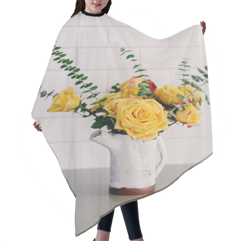 Personality  Yellow Large Roses And Eucalyptus Branches In The Ceramic Craft White Vase. Kitchen Counter Top. Lifestyle Bright Kitchen. Coffee Space In The Kitchen. Grey And White Colors. Bouquet Of Yellow Roses. Hair Cutting Cape