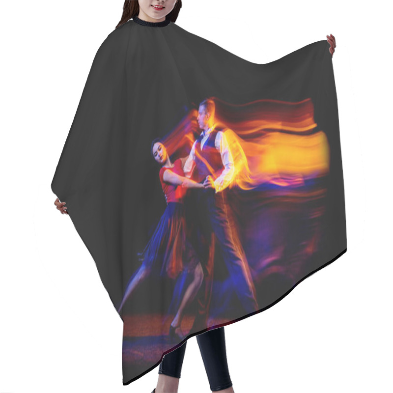 Personality  Dynamic Portrait Of Young Ballroom Dancers Dancing Argentine Tango Isolated On Dark Background With Neon Mixed Light. Hair Cutting Cape