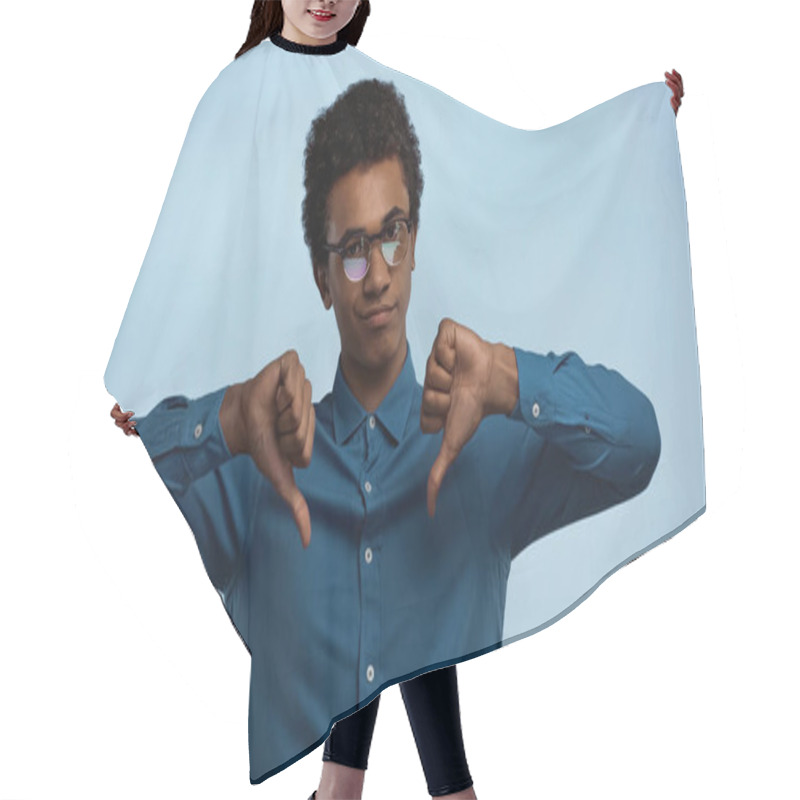 Personality  African American Teenage Boy In Glasses Showing Thumbs Down Isolated On Blue Hair Cutting Cape