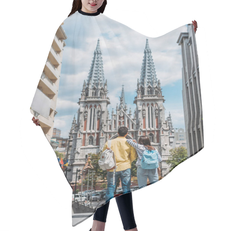 Personality  KYIV, UKRAINE - JULY 8, 2019: Back View Of Girl And Mixed Race Man Standing Near St. Nicholas Roman Catholic Cathedral Hair Cutting Cape