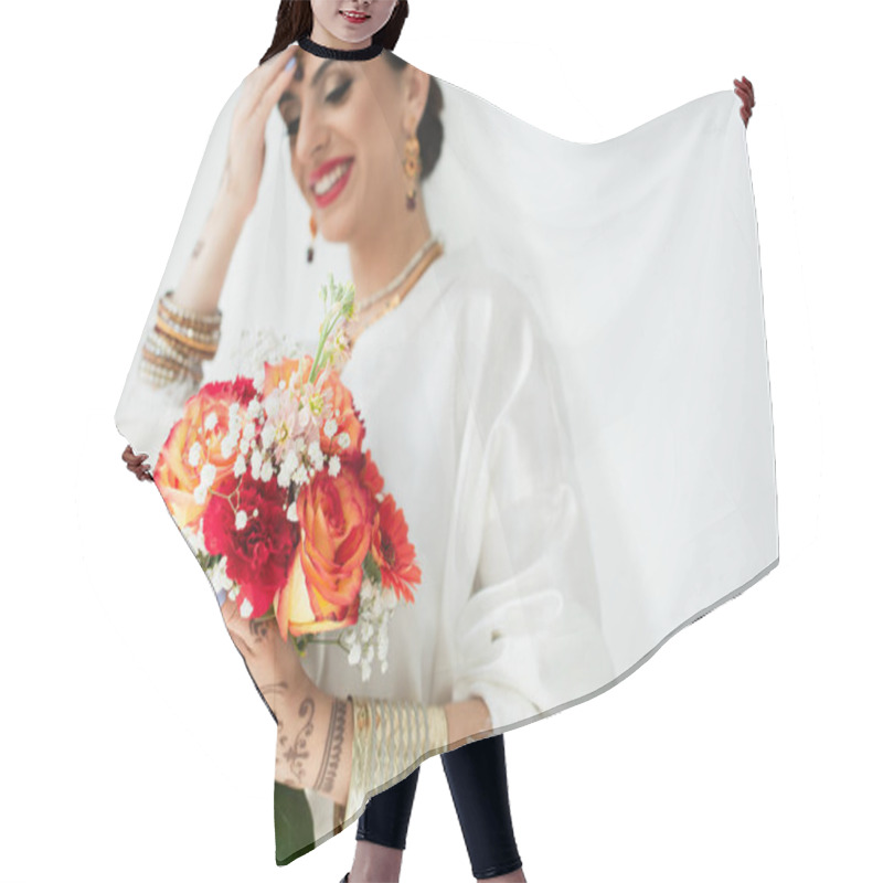 Personality  Young Blurred Indian Bride With Mehndi Smiling While Holding Bouquet Of Flowers On White Hair Cutting Cape