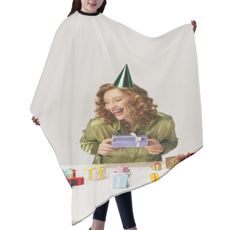 Personality  A Young Woman With Curly Hair Smiles As She Unwraps A Beautifully Wrapped Gift Surrounded By Others. Hair Cutting Cape