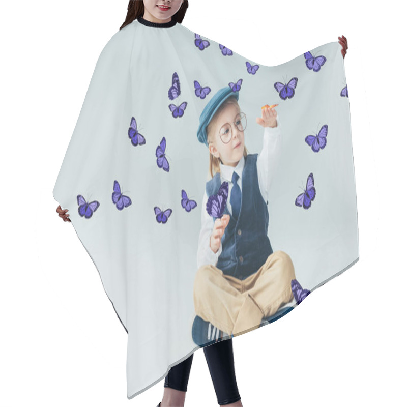 Personality  Adorable Kid Sitting On Floor With Crossed Legs Among Fairy Purple Butterflies On Grey Background  Hair Cutting Cape